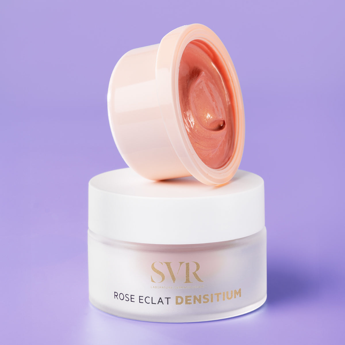 SVR Densitium Rose Eclat cream in a frosted glass jar with a pink refillable insert on a purple background.