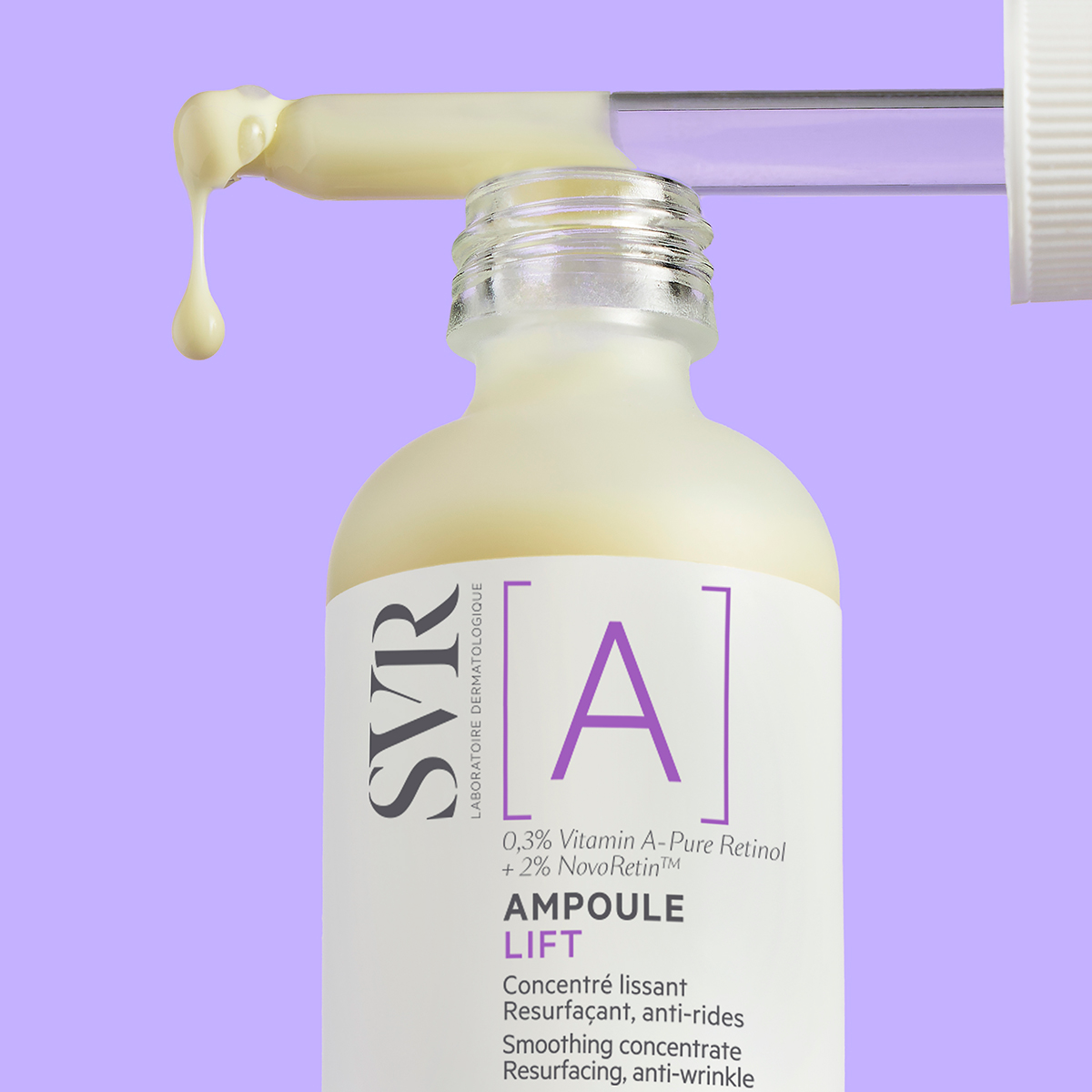 SVR [A] Ampoule Lift serum bottle with a glass dropper dispensing creamy yellow retinol concentrate on a purple background.